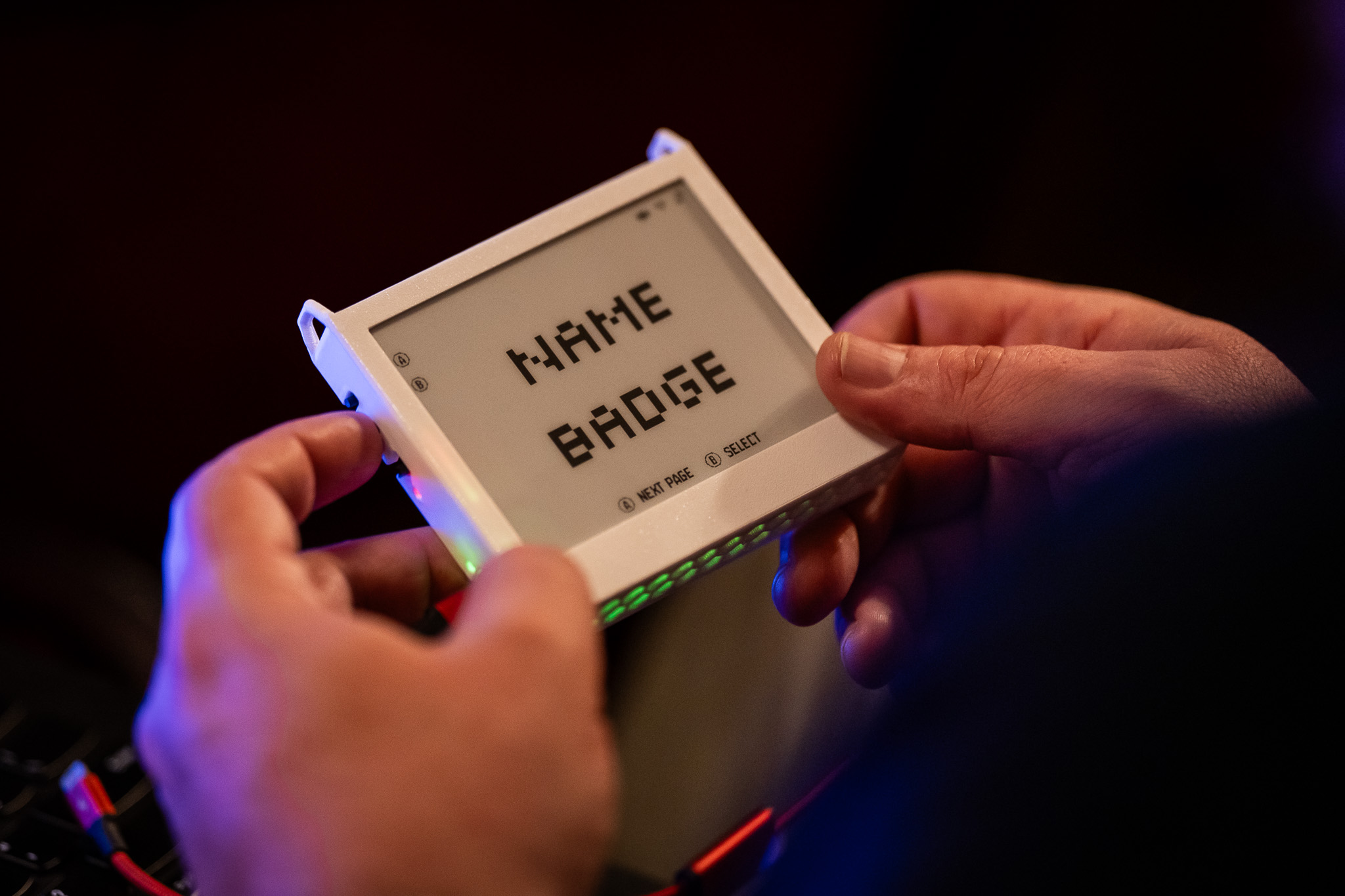 eInk name badge device showing the words NAME BADGE